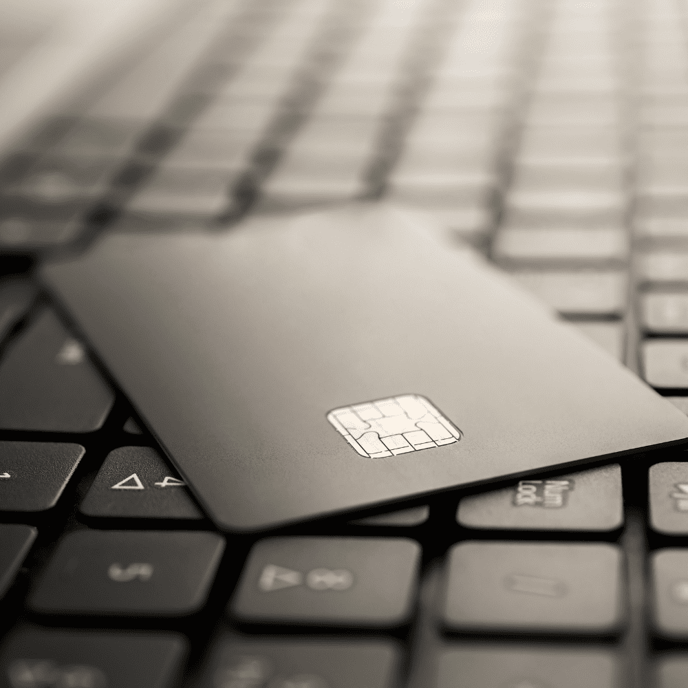 A credit card sitting on top of a keyboard.